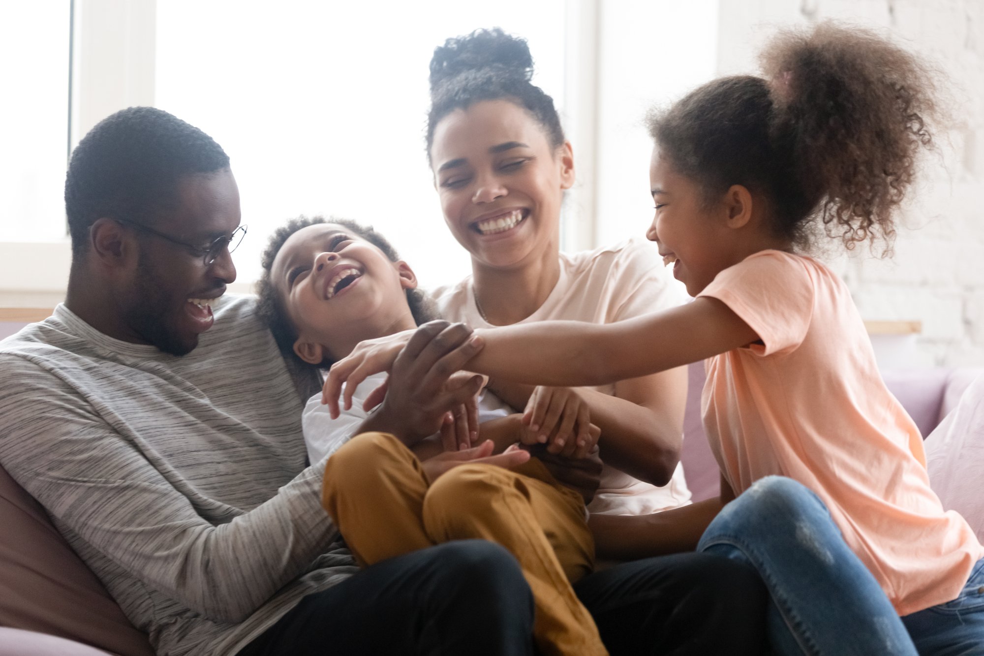 Happy family playing on the couch Happy family playing on the couch