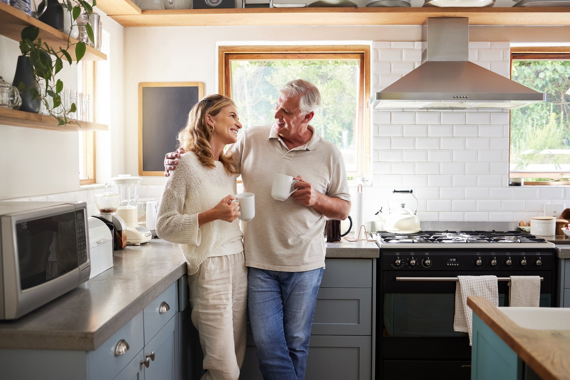 Senior couple drinking coffee in their kitchen Senior couple drinking coffee in their kitchen